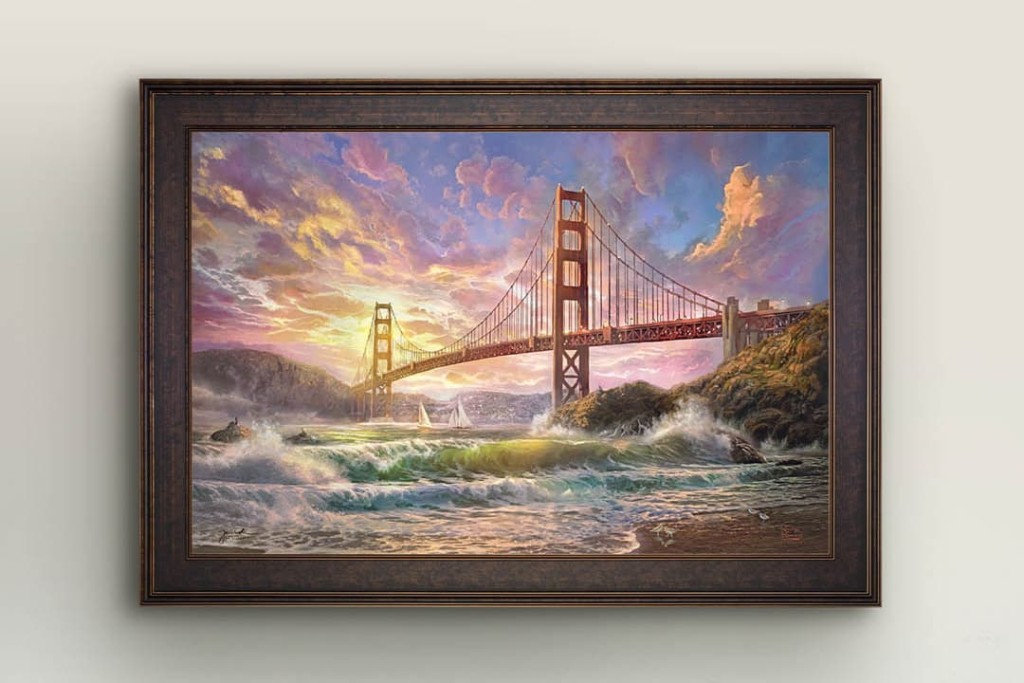 A framed Thomas Kinkade Studios paiting of the Golden Gate Bridge