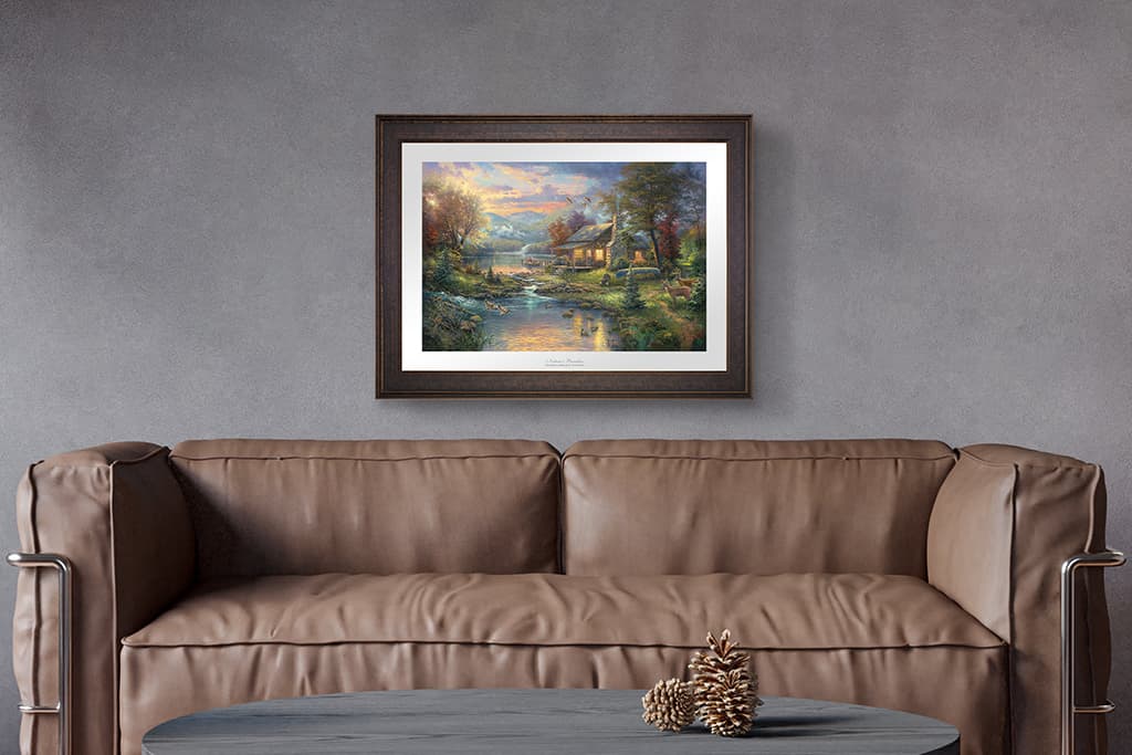 Thomas Kinkade Studios Limited Edition canvas, framed on a wall above a living room sofa